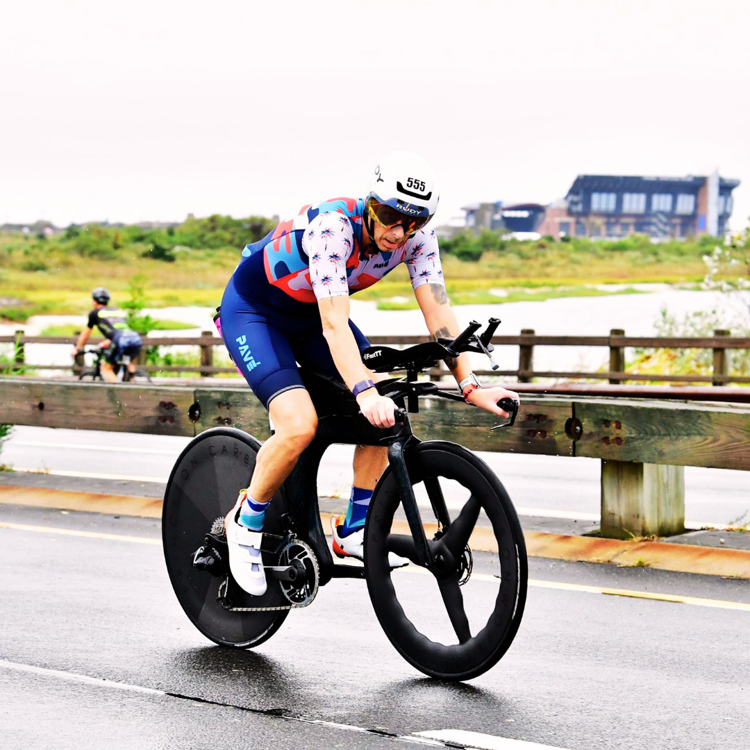 Pavé Sports founder Brett Heyes racing a time-trial bike in a custom trisuit