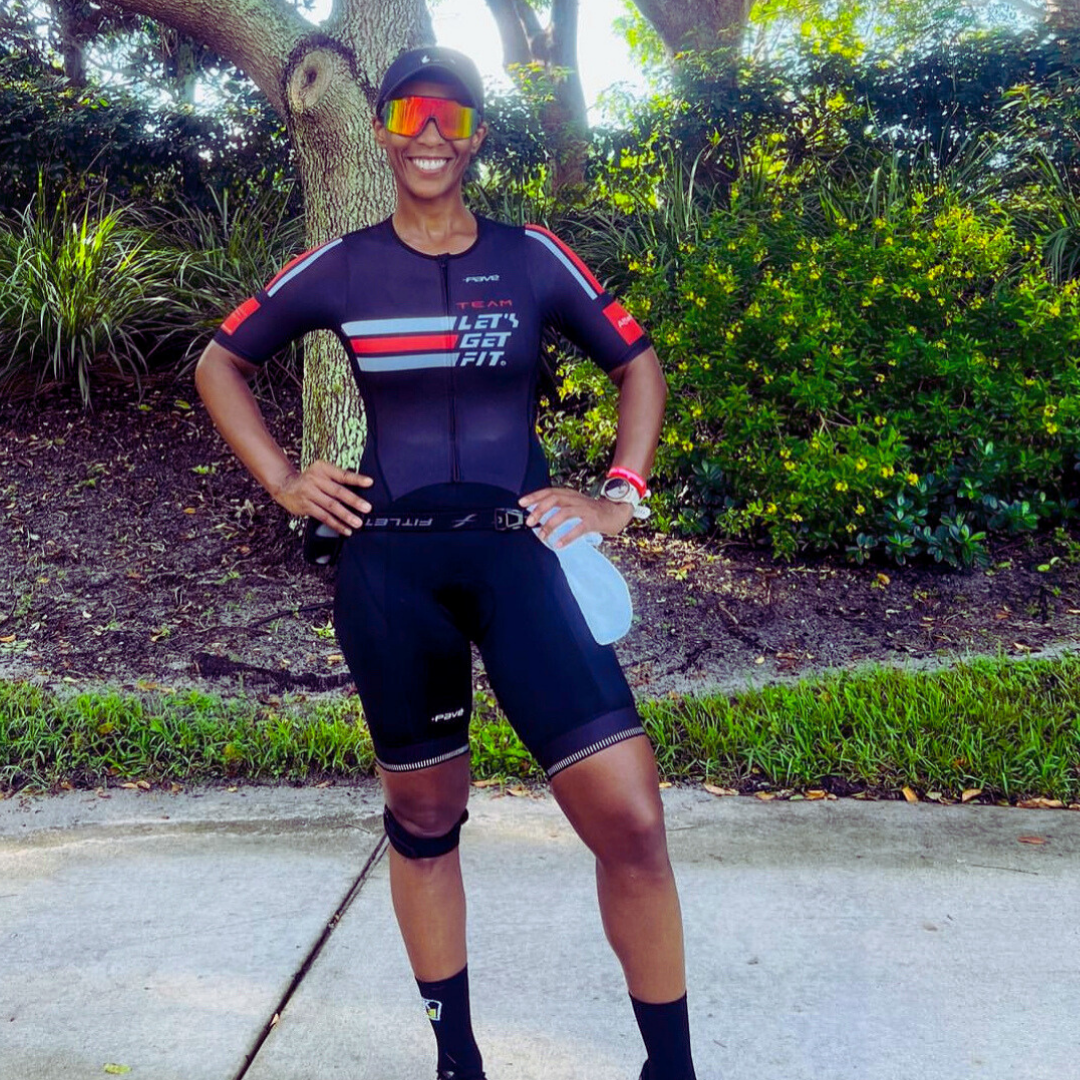 Triathlete in a custom Let's Get Fit trisuit made by Pavé Sports